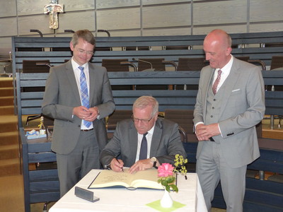 Staatssekretär Johannes Hintersberger trägt sich in das Goldene Buch des Landkreises ein